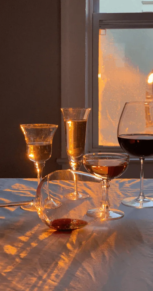 Amber-tinted and smoky gray glassware arranged on a festive fall dining table.