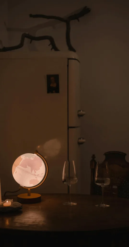 Table lamp casting soft warm light in a fall-themed bedroom.